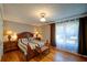 Cozy bedroom with hardwood floors, large window, and ample natural light, with ceiling fan at 3265 Bethesda Park Ct, Lawrenceville, GA 30044