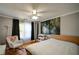 Comfortable bedroom with a plush white bed, wood floors, soft lighting, and a beautiful nature-themed wall art piece at 3265 Bethesda Park Ct, Lawrenceville, GA 30044