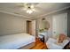 Charming bedroom featuring a cozy rocking chair, wood floors, and a vanity with a round mirror at 3265 Bethesda Park Ct, Lawrenceville, GA 30044