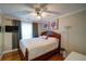 Cozy bedroom with a wooden bed frame, soft lighting, hardwood floors, and a TV for entertainment at 3265 Bethesda Park Ct, Lawrenceville, GA 30044