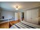 Inviting bedroom with wood floors, a striped comforter, and a sleek desk under the mirror at 3265 Bethesda Park Ct, Lawrenceville, GA 30044