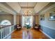 Elegant dining room boasting hardwood floors, large windows, and a decorative chandelier, perfect for entertaining guests at 3265 Bethesda Park Ct, Lawrenceville, GA 30044
