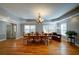 Spacious dining room featuring hardwood floors, a chandelier, and large windows for natural light at 3265 Bethesda Park Ct, Lawrenceville, GA 30044