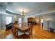 Formal dining room with hardwood floors, chandelier and ample space for entertaining, open to living room at 3265 Bethesda Park Ct, Lawrenceville, GA 30044