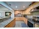 Modern kitchen with granite countertops, stainless steel appliances, tile floors, and light wood cabinets, offering style and functionality at 3265 Bethesda Park Ct, Lawrenceville, GA 30044
