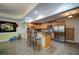 Well-lit kitchen showcasing tile floors, stainless steel appliances, a breakfast bar, and light wood cabinetry for ample storage at 3265 Bethesda Park Ct, Lawrenceville, GA 30044
