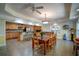 Open concept kitchen with an adjacent dining area, featuring tile floors, a breakfast bar, and stainless steel appliances at 3265 Bethesda Park Ct, Lawrenceville, GA 30044