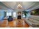 Bright living room featuring hardwood floors, tray ceilings, a fireplace, and neutral paint colors, and a variety of furniture at 3265 Bethesda Park Ct, Lawrenceville, GA 30044