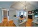 Bright living room features hardwood floors, a trey ceiling, fireplace, and neutral paint colors at 3265 Bethesda Park Ct, Lawrenceville, GA 30044