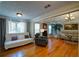 Inviting living room featuring hardwood floors, a fireplace, tray ceiling, neutral paint colors, and multiple seating options at 3265 Bethesda Park Ct, Lawrenceville, GA 30044
