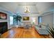 Cozy living room showcasing hardwood floors, a fireplace, neutral paint colors, and a tray ceiling with a decorative chandelier at 3265 Bethesda Park Ct, Lawrenceville, GA 30044