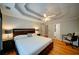 Large main bedroom with a tray ceiling, ceiling fan, hardwood floors, and ensuite bathroom at 3265 Bethesda Park Ct, Lawrenceville, GA 30044