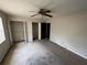 Bedroom featuring a ceiling fan, window, and ample closet space at 2572 Stratford Ln, Morrow, GA 30260