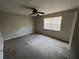 Bedroom with ceiling fan, window, and neutral walls at 2572 Stratford Ln, Morrow, GA 30260