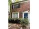 Close up image of the exterior of a brick home with shrubs and a blue door at 2572 Stratford Ln, Morrow, GA 30260