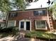 Brick townhouse with a traditional facade and a small front yard, offering a classic and inviting curb appeal at 2572 Stratford Ln, Morrow, GA 30260