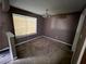 A spacious living room with a window provides natural light, enhancing the room's appeal and comfort at 2572 Stratford Ln, Morrow, GA 30260