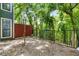Scenic backyard with gravel, green trees, and fencing at 2814 Vinings Central Se Dr # 151, Atlanta, GA 30339