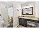 A clean bathroom with a granite countertop, vanity, and a shower with a patterned shower curtain at 2814 Vinings Central Se Dr # 151, Atlanta, GA 30339