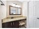 Bathroom vanity featuring granite counters and an ornate mirror at 2814 Vinings Central Se Dr # 151, Atlanta, GA 30339