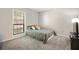 Bedroom with neutral decor, plush carpet, and a large window providing natural light at 2814 Vinings Central Se Dr # 151, Atlanta, GA 30339