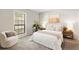 Cozy bedroom with a large window, comfortable chair, and bedside tables with lamps at 2814 Vinings Central Se Dr # 151, Atlanta, GA 30339