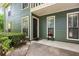 Charming home exterior with green siding, trimmed windows, and a welcoming porch adorned with vibrant flowers at 2814 Vinings Central Se Dr # 151, Atlanta, GA 30339
