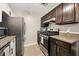 Well-equipped kitchen featuring stainless steel appliances, granite counters, and tile floors at 2814 Vinings Central Se Dr # 151, Atlanta, GA 30339