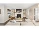 Bright living room with fireplace, built-in shelving, and shuttered windows at 2814 Vinings Central Se Dr # 151, Atlanta, GA 30339