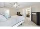 Spacious main bedroom featuring a ceiling fan, TV, neutral carpet, and access to the bathroom at 2814 Vinings Central Se Dr # 151, Atlanta, GA 30339