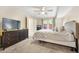 Spacious main bedroom featuring a ceiling fan, TV, neutral carpet, and natural light at 2814 Vinings Central Se Dr # 151, Atlanta, GA 30339