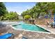 Resort-style pool area with a waterfall feature, blue lounge chairs, and lush green landscaping at 2814 Vinings Central Se Dr # 151, Atlanta, GA 30339