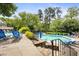 Community pool with lounge chairs and a beautiful, landscaped pool deck and stone stair access at 2814 Vinings Central Se Dr # 151, Atlanta, GA 30339