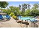 Community pool surrounded by lush landscaping and lounge chairs, creating a relaxing oasis for residents at 2814 Vinings Central Se Dr # 151, Atlanta, GA 30339