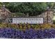 Vinings Central Condominiums sign framed by stone pillars and vibrant purple and pink flowers at 2814 Vinings Central Se Dr # 151, Atlanta, GA 30339