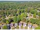 Expansive aerial shot of a residential neighborhood featuring lush trees and various homes in a serene setting at 5035 Pattingham Dr, Roswell, GA 30075