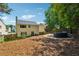 Spacious backyard with a stone patio featuring outdoor seating and a partly wooded area providing a tranquil setting at 5035 Pattingham Dr, Roswell, GA 30075