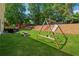 Lush backyard with a playset, picnic table, and patio, perfect for outdoor fun and relaxation at 5035 Pattingham Dr, Roswell, GA 30075