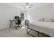 Comfortable bedroom with a bed, desk, and chair, ideal for relaxing or studying, with neutral colors and lots of light at 5035 Pattingham Dr, Roswell, GA 30075