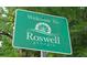 Green sign welcoming visitors to Roswell, Georgia, a beautiful place to live and visit at 5035 Pattingham Dr, Roswell, GA 30075