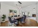 Bright dining area featuring a modern chandelier, seating for six and an open view to the living room at 5035 Pattingham Dr, Roswell, GA 30075