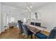 Open concept dining and living area features hardwood flooring and modern lighting at 5035 Pattingham Dr, Roswell, GA 30075