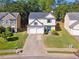 Charming two-story home with a well-manicured lawn, double garage, and inviting front entrance at 5035 Pattingham Dr, Roswell, GA 30075