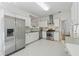Bright kitchen with white cabinets, stainless steel appliances, and modern finishes throughout at 5035 Pattingham Dr, Roswell, GA 30075
