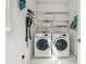 Functional laundry room with a washer, dryer, and shelving, offering a convenient space for laundry tasks at 5035 Pattingham Dr, Roswell, GA 30075