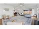 Open concept living area featuring a fireplace, ceiling fan, and hardwood flooring at 5035 Pattingham Dr, Roswell, GA 30075