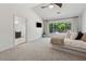 Main bedroom featuring carpet floors, backyard view, and en-suite at 5035 Pattingham Dr, Roswell, GA 30075