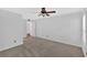 Carpeted bedroom has ceiling fan, view to the hallway and window with natural light at 1438 N Crossing Ne Dr, Atlanta, GA 30329