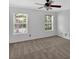 Neutral-carpeted bedroom is bright with natural light from two large windows and has a ceiling fan at 1438 N Crossing Ne Dr, Atlanta, GA 30329