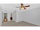 Bedroom features neutral carpet, ceiling fan, and doorway to an en suite bathroom at 1438 N Crossing Ne Dr, Atlanta, GA 30329